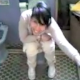 A Spanish girl is video recorded while sitting on a toilet taking a shit in this low resolution, small video clip.